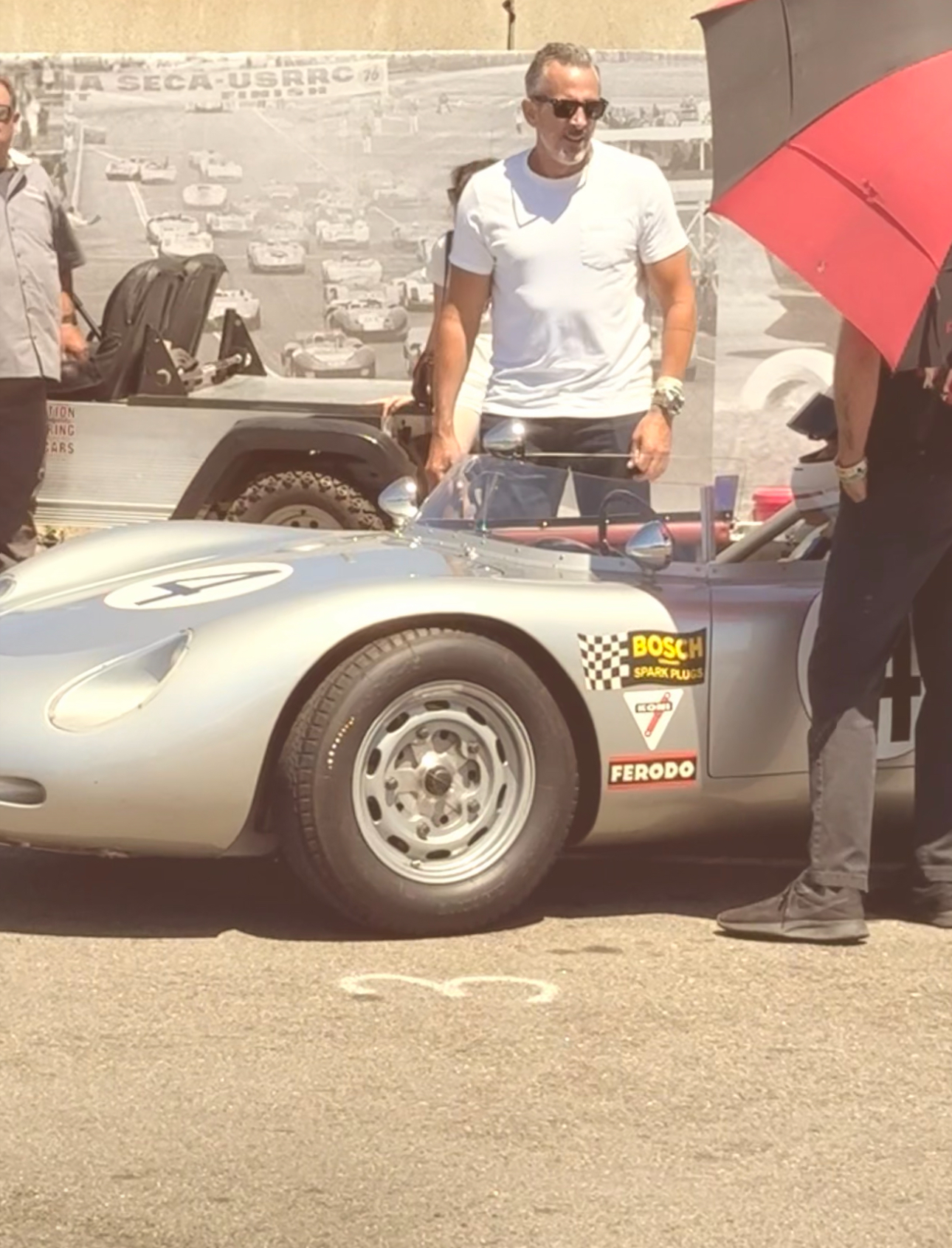 eMotoring founder Scott Gladstone at a vintage motorsport event beside a 1959 Porsche RSK